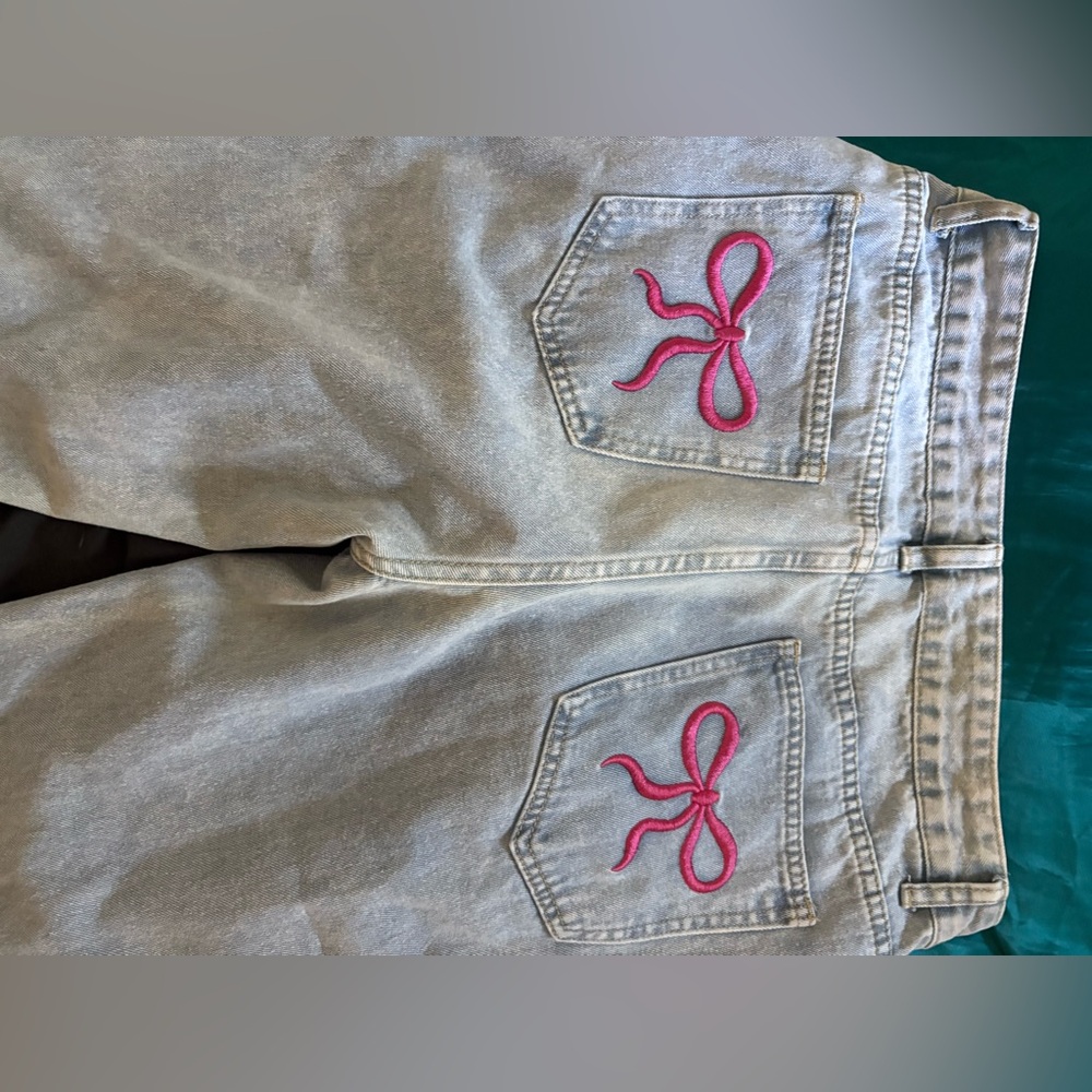 Stylish Light Blue Jeans with Pink Bow Accents